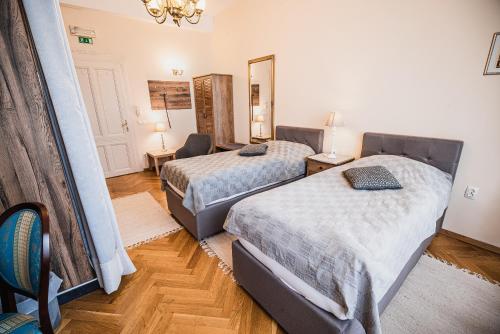 a hotel room with two beds and a mirror at Guest House Veronika in Kočevje