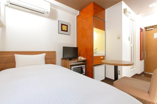 Postel nebo postele na pokoji v ubytování FLEXSTAY INN Kawasaki Ogawacho