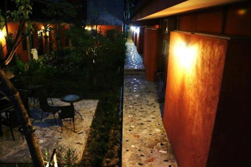 a walkway in a garden at night with lights at 2 Home in Chalong 