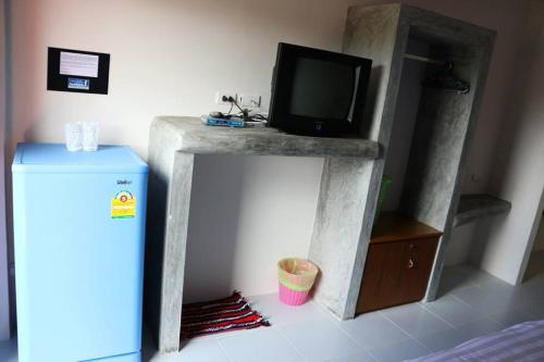 a tv sitting on top of a stand in a room at 2 Home in Chalong 