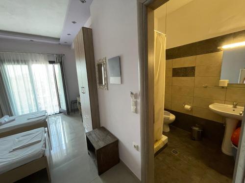 a bathroom with a toilet and a sink at Serenity Studios in Kala Nera
