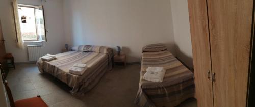 Ένα ή περισσότερα κρεβάτια σε δωμάτιο στο B&B Nonno Pino