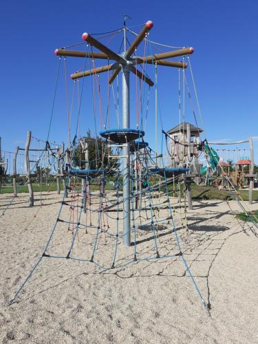 an empty playground with a swing set in the sand at UBYTOVÁNÍ NA SPRÁVNÉM MÍSTĚ in Znojmo