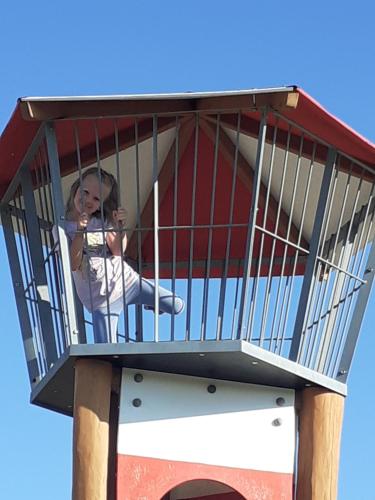a young girl sitting in a bird cage at UBYTOVÁNÍ NA SPRÁVNÉM MÍSTĚ in Znojmo