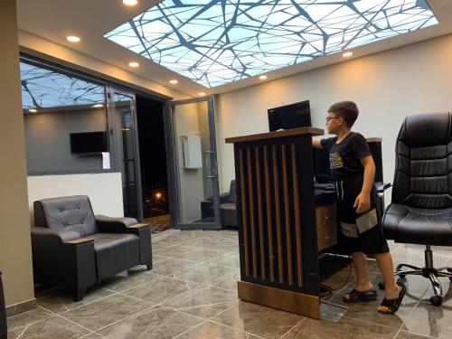 a man standing at a podium in a room at NURALP APART OTEL - Trabzon in Trabzon