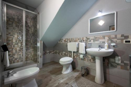 a bathroom with a sink and a toilet and a shower at Il Corallo in Castellammare del Golfo
