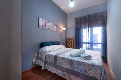 a small bedroom with a bed and a window at Il Corallo in Castellammare del Golfo