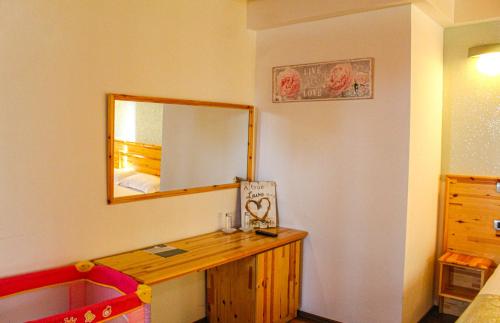a room with a mirror and a wooden dresser at Shkreli Resort Qafeshtame in Krujë