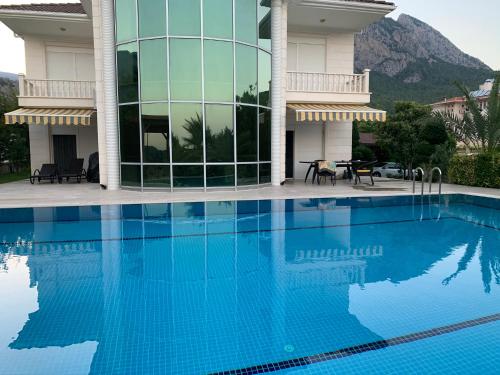 a large swimming pool in front of a building at Luxury Villa for rent in Kemer, Göynük Antalya in Antalya