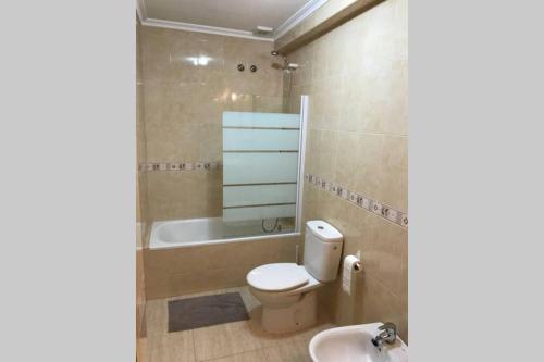 a bathroom with a toilet and a tub and a sink at Casa, sol y playa 365 días!! in San Juan de los Terreros