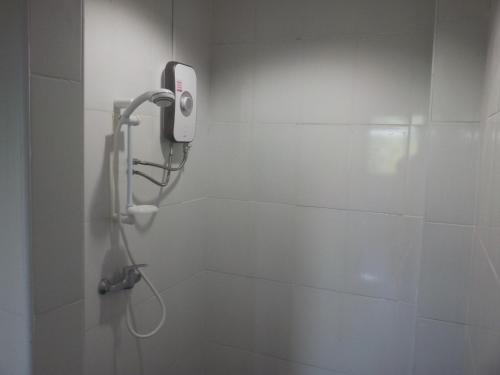 a bathroom with a shower with a phone on the wall at Living Room Apartments Bang Lut Beach KhaoLak in Bang Sak