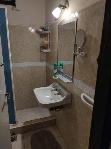 a bathroom with a sink and a mirror at Residencia Don Roque in Santa Rosa