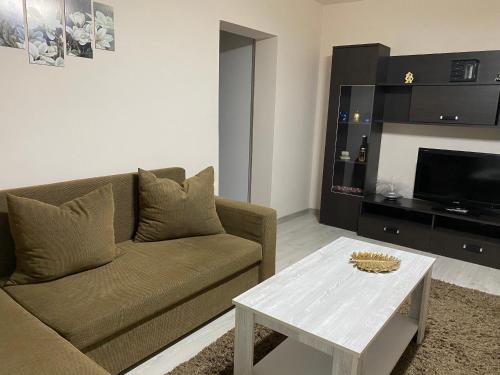 a living room with a couch and a coffee table at SELLADA APARTAMENT - Free Private Parking,AC,Wi-Fi in Carei