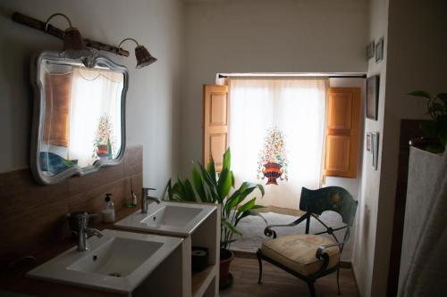 a bathroom with two sinks and a mirror at El Carmen in Ribera Alta