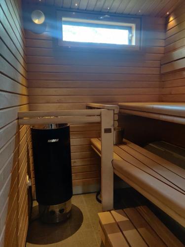 a small sauna with a trash can in it at SiikaVilla, Siikajoki in Siikajoki
