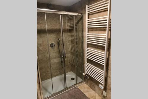 a shower with a glass door in a bathroom at Vila Slavc, cosy apartment near the lake in Bled