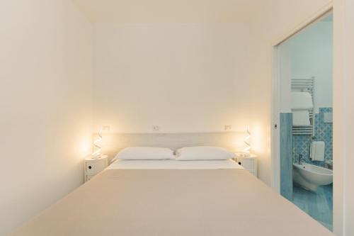 A bed or beds in a room at Poseidonia Rooms