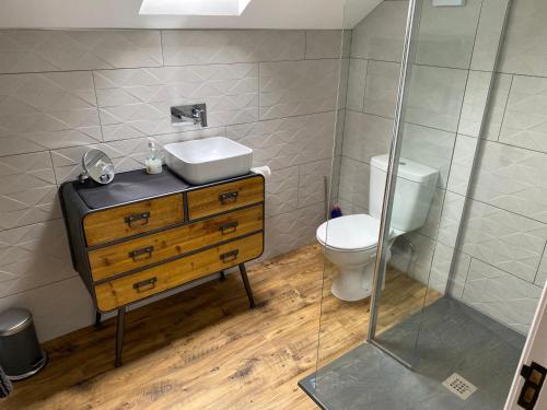 a bathroom with a sink and a toilet at Hygge Homes - Modern 1 bed house in Lincoln