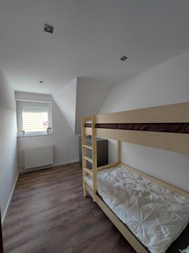 a bedroom with two bunk beds and a window at Bagoly Apartman in Eger