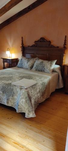 a bedroom with a bed with a laptop on it at Hotel Rural el Arrabal Siguenza in Sigüenza
