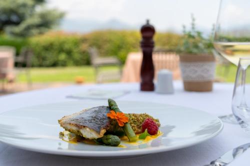 a white plate with food on a table at La Corte di Lurago in Lurago D'Erba 