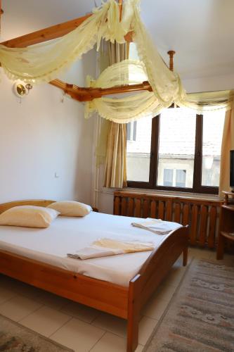 una camera da letto con un letto a baldacchino di Hotel Mishel a Kocherinovo