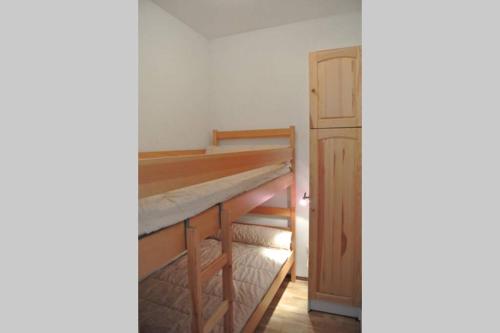 a room with two bunk beds and a cabinet at Font-Romeu La Plane Sud - vue panoramique in Font Romeu Odeillo Via