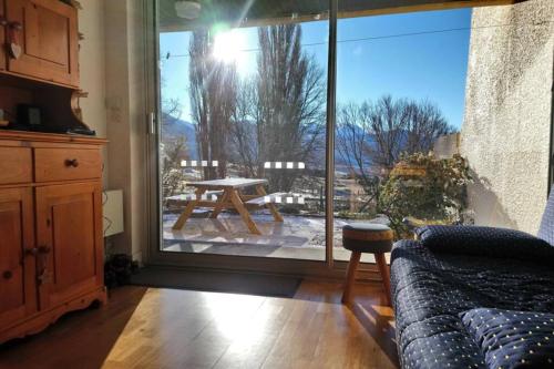 a living room with a table and a large window at Font-Romeu La Plane Sud - vue panoramique in Font Romeu Odeillo Via
