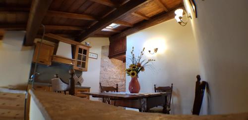 a kitchen and dining room with a table and chairs at Relax Colleverde in Colle Verde