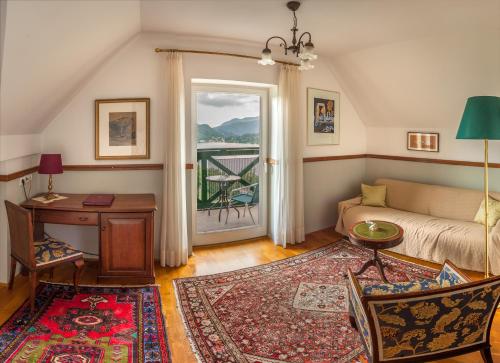 a living room with a couch and a table at Hotel Triglav in Bled