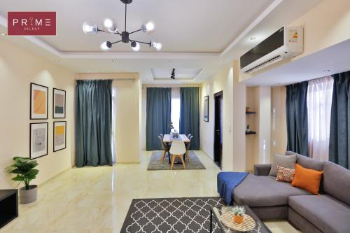 a living room with a couch and a table at Prime Select Point 90 Mall in Cairo