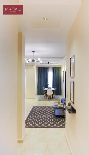 a living room with a table and a couch at Prime Select Point 90 Mall in Cairo