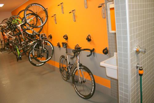 two bikes are hanging on a wall in a bathroom at Hotel Larice Bianco in Bormio
