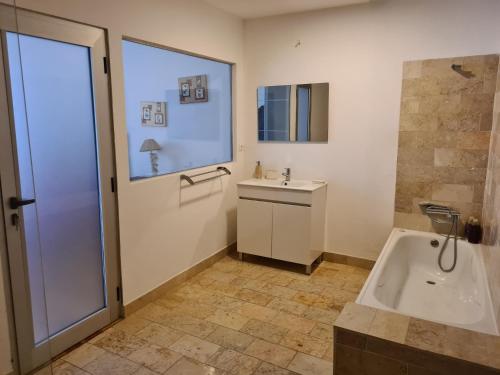 a bathroom with a tub and a sink at Casa do Armador in Setúbal