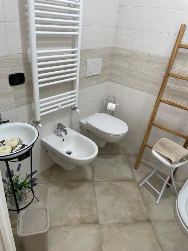a bathroom with a sink and a toilet and a bidet at casa Belcolle in Putignano
