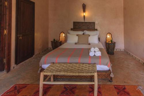 a bedroom with a large bed with shoes on it at Riad Nabila in Marrakesh