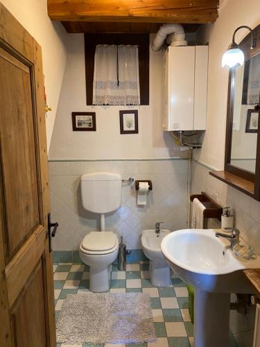a bathroom with a toilet and a sink at Frazione Duc Apartments in Sestriere