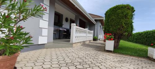 a house with a walkway in front of it at Marica Vendégház in Bük