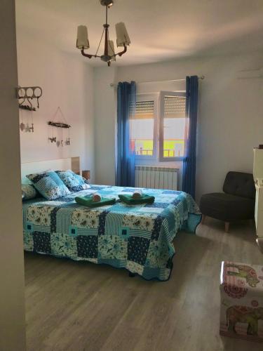 a bedroom with a bed with a quilt on it at Galicia47 in Zamora