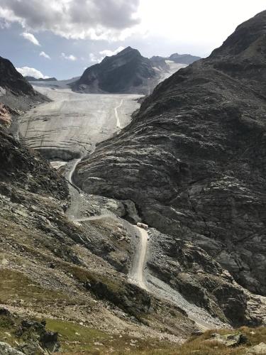 a mountain with a dirt road on the side at Haus am Steinbockzentrum in Sankt Leonhard im Pitztal
