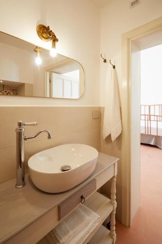 a bathroom with a sink and a mirror at Petra - Country House in Monteroni di Lecce