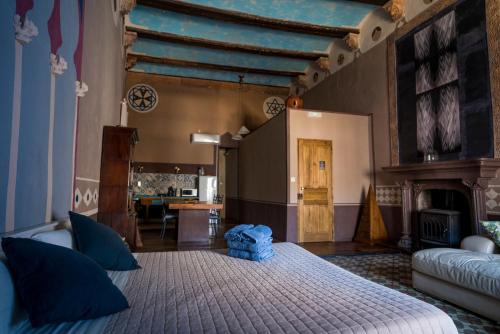 a bedroom with a large bed with blue pillows at DOMUS AMABILIS - ESPAI GAETA in Sagunto