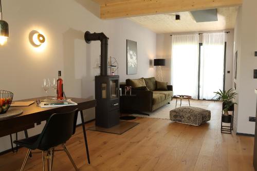 a living room with a table and a living room with a couch at Seehaus Kärnten in Saager