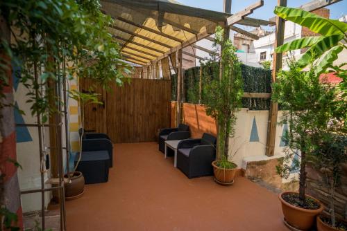 a patio with couches and potted plants at DOMUS AMABILIS - ESPAI GAETA in Sagunto