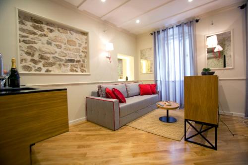 a living room with a couch and a table at Borelli Palace & Borelli Blue in Zadar