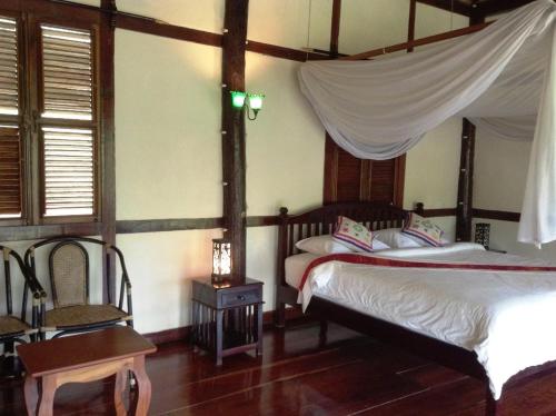 A bed or beds in a room at Lao Spirit Resort