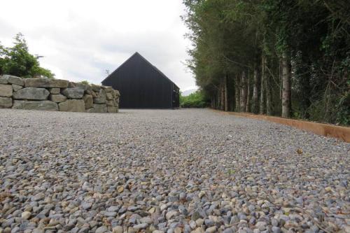a large gravel road with a building in the background at The Boat Shed, Westport in Westport