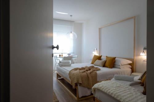 a bedroom with two beds and a couch in it at La Sirena Rooms in Giardini Naxos