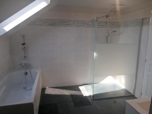 a bathroom with a shower and a tub with a glass door at La Voilerie in Fécamp