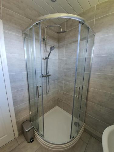 a shower with a glass enclosure in a bathroom at PREMIER - Kenilworth House in Holytown